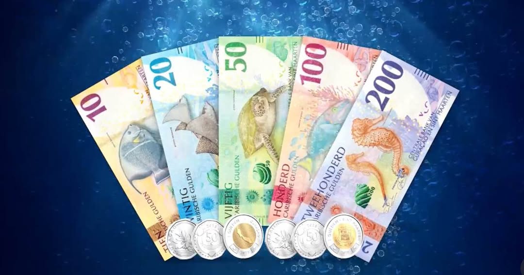 Colorful Caribbean guilder (XCG) banknotes and coins introduced in Curaçao in 2025, featuring marine life designs.